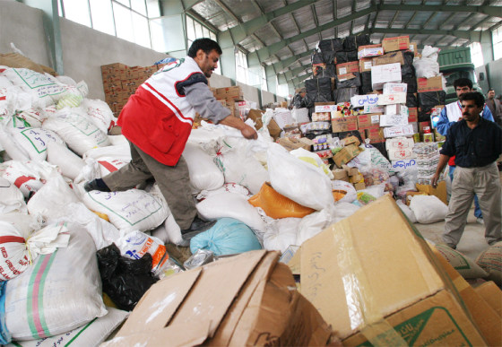 AID IS SORTED FOR DISTRIBUTION IN A WAREHOUSE OUTSIDE BAM IRAN
