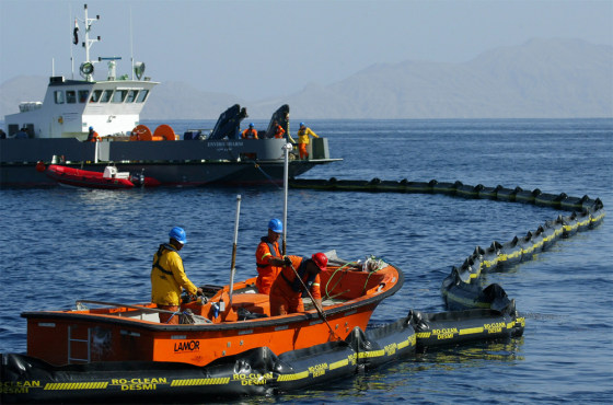 Egyptian environmental workers gather debris from the wreckage of an Egyptian charter airplane Monday at the crash scene in the Red Sea off the resort city of Sharm el-Sheik, Egypt.