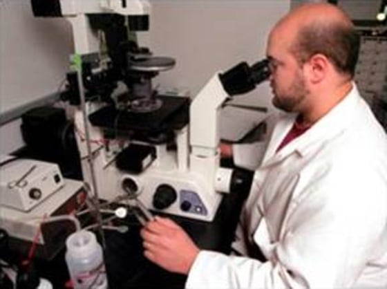 ACT research associate Mark Maserati uses one of the most advanced microscopes in the U.S. to magnify an egg many times over so he can remove its genetic material — the first step in therapeutic cloning — at the company’s Worcester, Mass., facility.