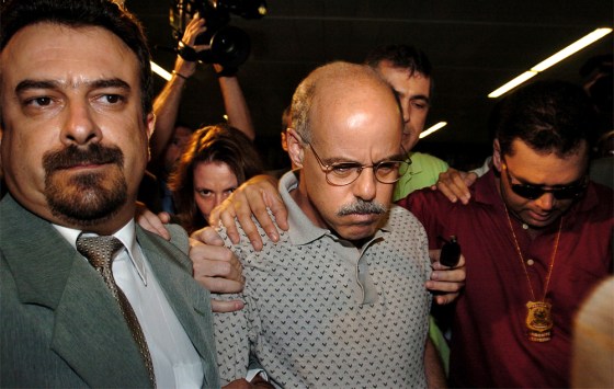 Brazilian federal police escort American Airlines pilot Dale Robin Hersh at the Sao Paulo's International Airport of Guarulhos on Wednesday.