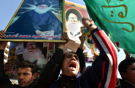 At a demonstration in Baghdad Tuesday, Shiite Muslims carrying flags and posters of clerical leader Mohammed Sadiq al-Sadr call for Saddam Hussein's execution. 
