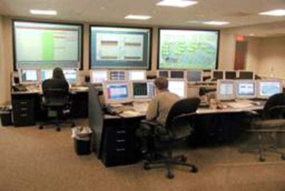 Technicians monitor Internet traffic in a Verisign network operating center. A new center has recently gone operational and will replace the one seen here.