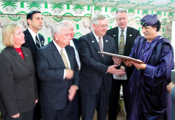Libyan leader Moammar Gadhafi accepts a plaque from Rep. Curt Weldon, R-Pa. during a meeting with a U.S. congressional delegation in Tripoli Monday. From left are Candice Miller, R-Mich., Darrell Issa, R-Calif., Elton Gallegly, R-Calif., Solomon Ortiz, D-TX, Weldon, Rodney Alexander, D-La., and Gadhafi. 