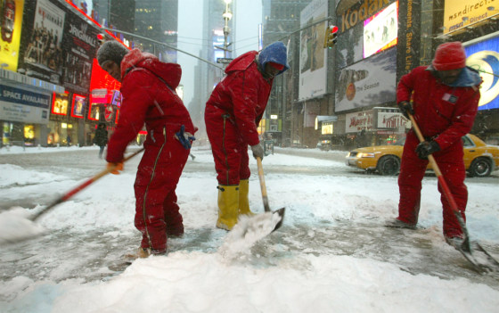Workers shovel snow Wednesday in New York. 