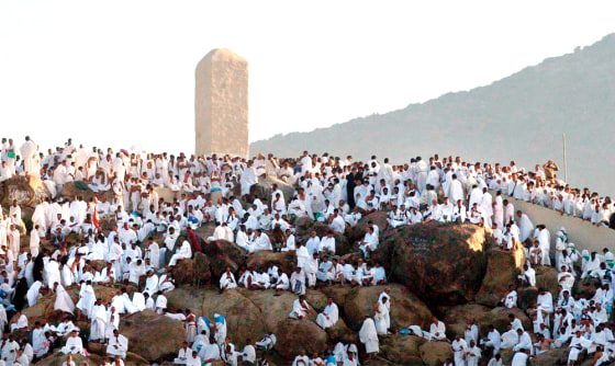 Muslim pilgrims pray arround the holy stone, center, on Mount Arafat, northeast of the city of Mecca, during the annual Muslim hajj on Saturday.