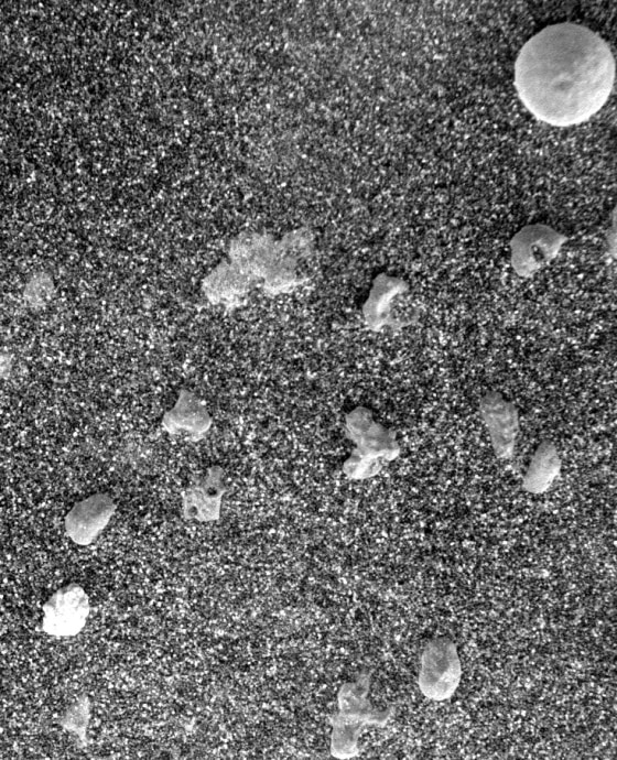 An extreme close-up from the Opportunity rover's microscopic imager shows the area's dark soil, speckled with pebbles and an unusual round rock.