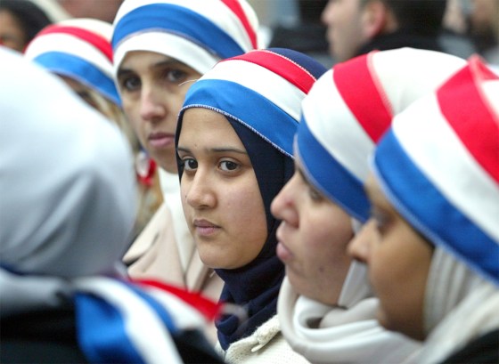 Young women wear headbands in the colors of the French flag during protests in Paris on Jan. 17.