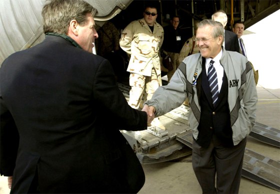 U.S. Defense Secretary Donald Rumsfeld, right, is greeted off a C-130 transport plane by U.S. administrator Paul Bremer in Baghdad on Monday.