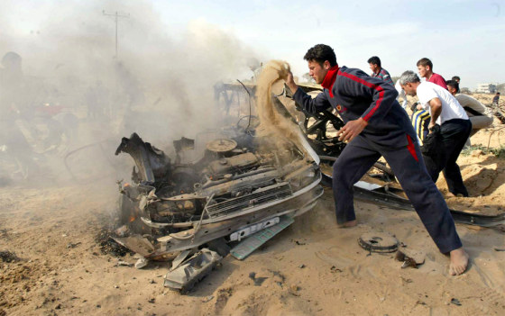 PALESTINIANS TRY TO EXTINGUISH THE FIRE AFTER ISRAELI AIRCRAFT FIRED AT A CAR IN GAZA