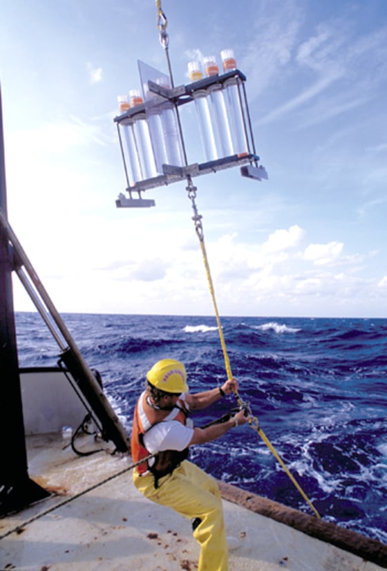 Scientists and crew aboard the R/V Weatherbird II collect samples from the Sargasso Sea.