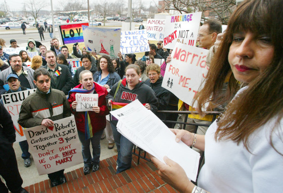 Laurie Murray, right, Deputy Town Clerk for the Town of Brookhaven turns away after reading a statement that the town would not be issuing same-sex marriage licenses to a crowd of gay couples and their supporters in Patchogue, N.Y., Friday.