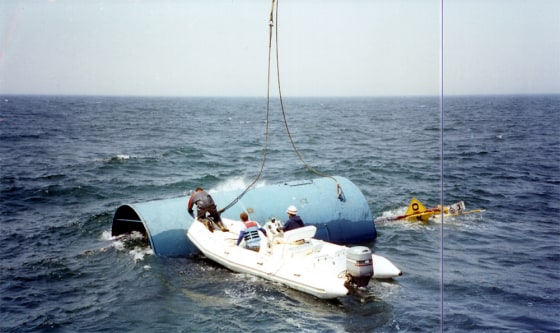 Ocean Power Technologies crew prepare to lift a turbine upright so that it will bob in the ocean, creating energy. This test was undertaken off the New Jersey coast.