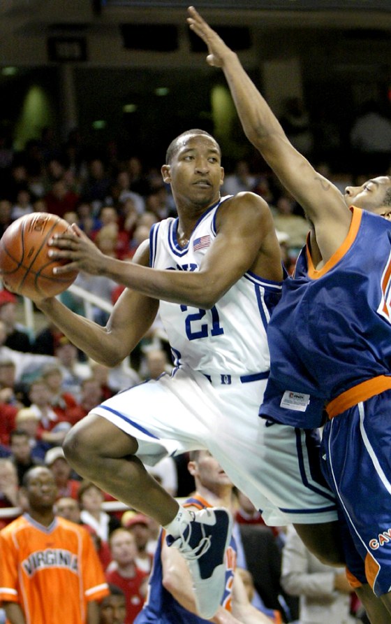 DUKE'S CHRIS DUHON LOOKS TO MAKE A PASS AROUND VIRGINIA'S T.J. BANNISTER