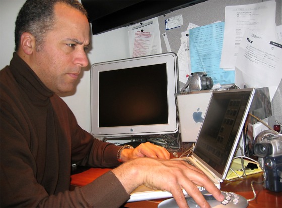 Lester Holt sits in front of his home computer set-up.