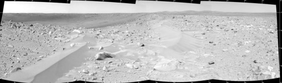 A panorama created by the Spirit rover's navigation camera shows drifts of windblown material along the rim of Bonneville crater on Mars.