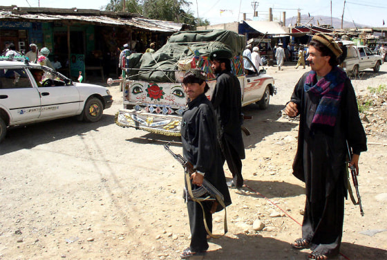 PAKISTANI TRIBAL GUARDS STAND ALERT AT A CHECK POINT IN WANA