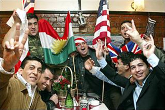 Members of the Kurdish community celebrate in the Tara restaurant in North London last month after the northern city of Kirkuk was captured by coalition forces.