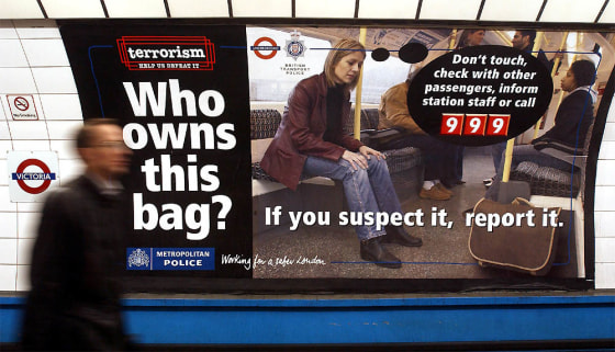 POSTER ASKING MEMBERS OF PUBLIC TO REPORT SUSPECT BAGS IS SEEN AT VICTORIA UNDERGROUND STATION LONDON