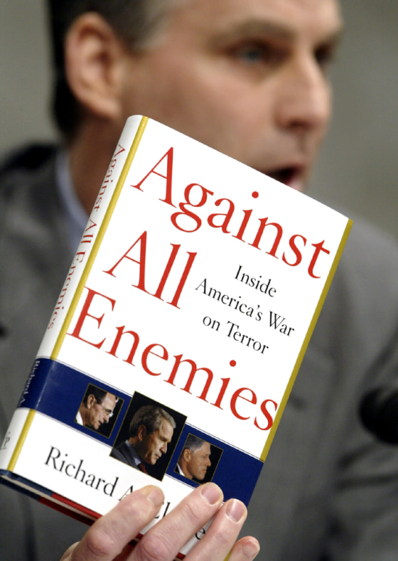 COMMISSION PARTICIPANT TIMOTHY ROEMER HOLDS UP A COPY OF RICHARD CLARKE'S BOOK IN WASHINGTON