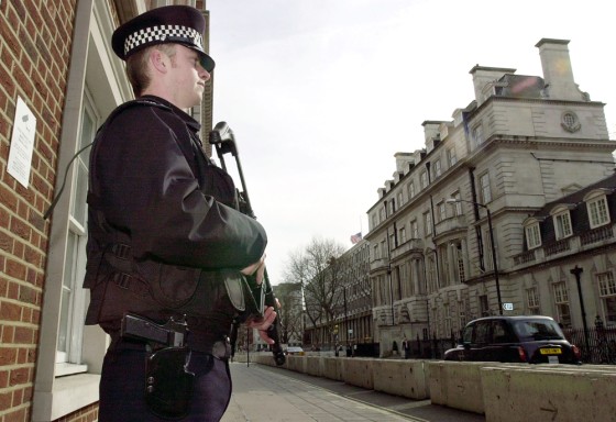 An armed British policeman stands guard on a street leading to the U.S. embassy in London's Grosvenor Square. Security in London remains high since the terrorist attack in Madrid in early March.