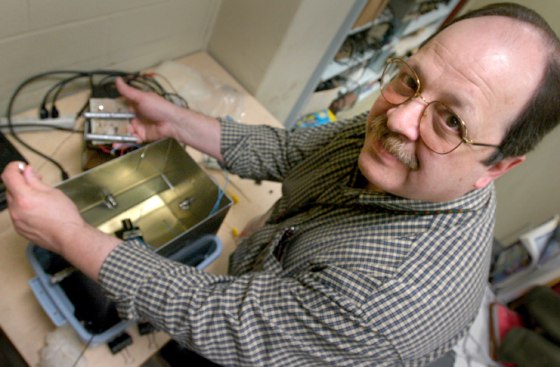 Harry Roman demonstrates how he and his team at the New Jersey Institute of Technology used a protype test tank to prove the scientific principles of the transformer sensors.