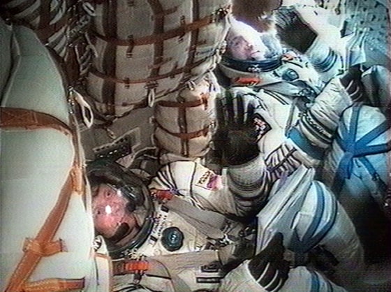 Russian Gennady Padalka, left, and Andre Kuipers of the Netherlands are seen waving en route to the international space station after blast-off Monday.