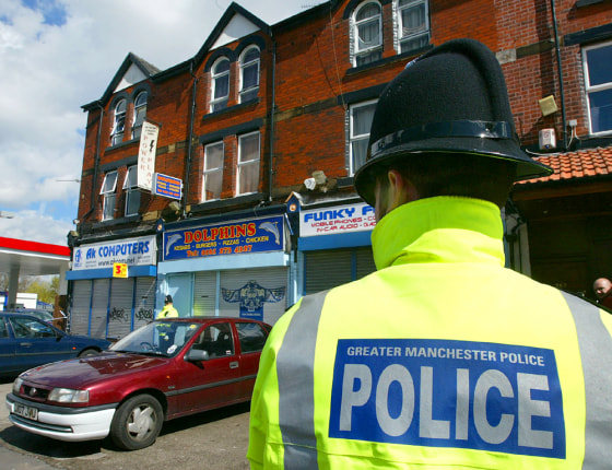BRITISH POLICE STAND GUARD OUTSIDE PROPERTY WHERE RAIDS WERE CARRIED OUT IN MANCHESTER