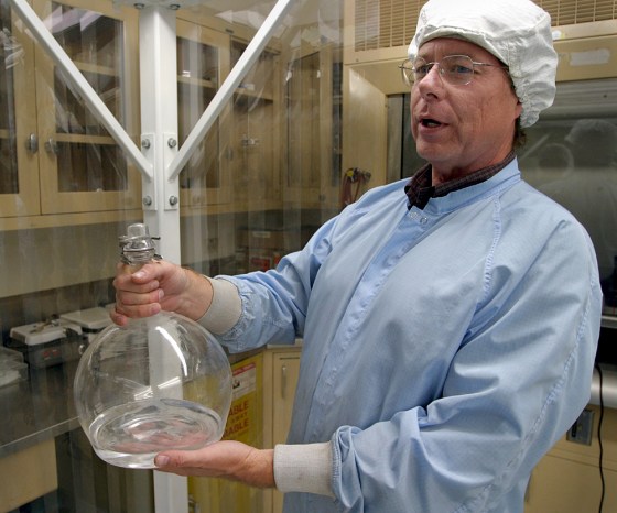 Steven Jones, a researcher at NASA's Jet Propulsion Laboratory, holds a flask containing a clear liquid that will be turned into aerogel.