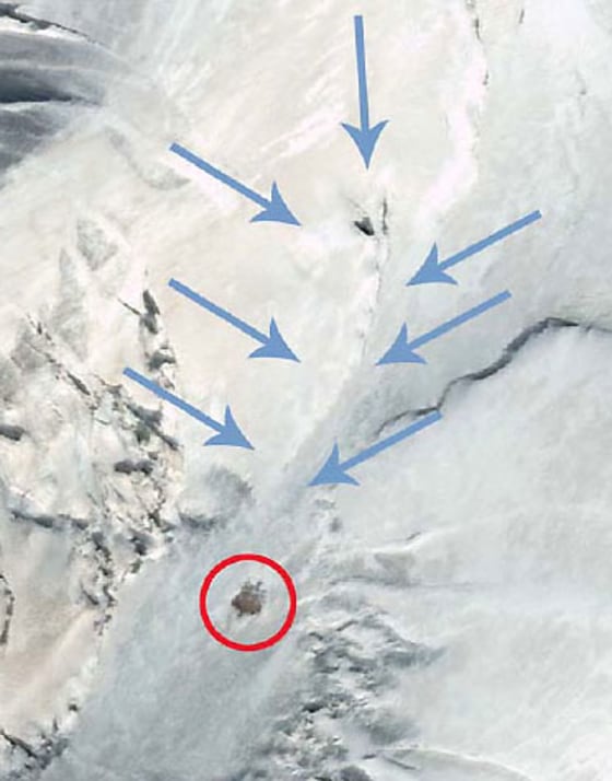 Satellite imagery of Turkey's Mount Ararat highlights an object within a red circle, with blue arrows indicating possible downslope movement. The imagery was captured by Digital Globe and made available through Shamrock-The Trinity Corp. Explorers hope to determine whether the object is linked to the story of Noah's Ark. Click on the image to explore the scene using the Space.com "ZoomViewer."