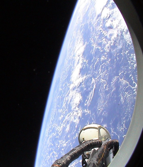 Earth and the blackness of space loom outside the window of a Soyuz space capsule in a picture taken by Dutch astronaut Andre Kuipers.