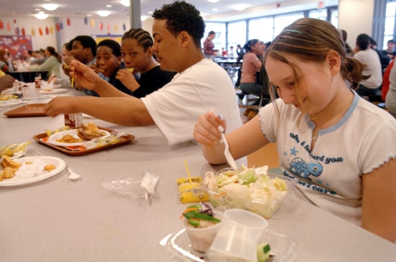 Seventh graders Stephanie Aurora, 12, right, Niko Taylor, 13, center, eat lunch at Nathan Hale School in New Haven, Conn., on April 15. 