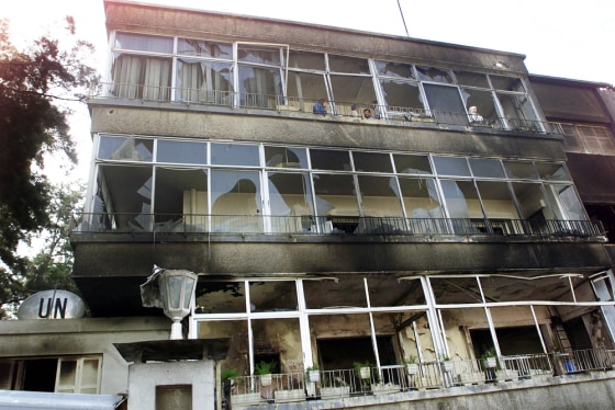 An empty former UN building which was damaged in a bomb blast Tuesday evening, is seen on Wednesday, after gunmen and police fought an armed battle in a diplomatic quarter west of Damascus, Syria. 