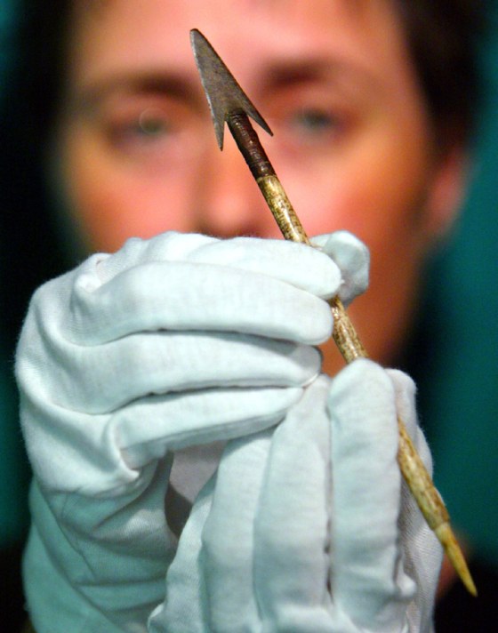 JUDE PHILP HOLDS AN ARROW HEAD WITH A BONE SHAFT IN SYDNEY