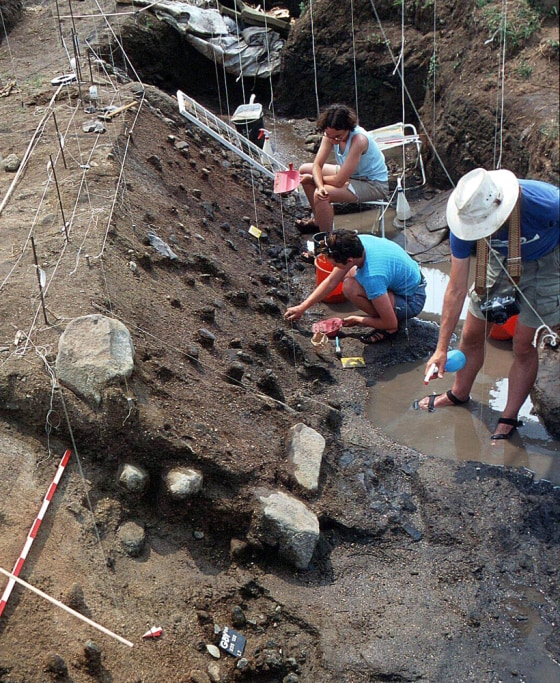 Researchers work at an excavation site at Gesher Benot Ya'aqov in Israel. Among the artifacts discovered there were remains of burned wood, tiny flint pieces, bones with cut marks and a variety of grains.
