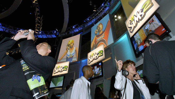 Visitors browse "The Sims 2" at the Electronic Entertainment Exposition in Los Angeles. In the sequel, Sims can now feel love -- and lust.