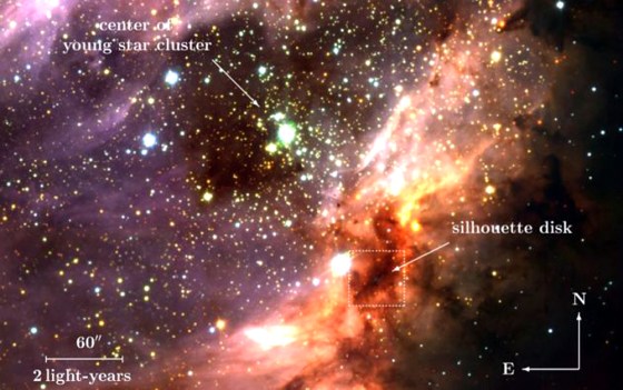 An image of the Omega Nebula and a cluster of hot, young stars taken by the European Southern Observatory's Very Large Telescope. The silhouetted disk is below and to the right of the cluster, indicated by a square.