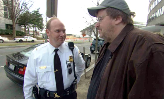 Michael Moore is stopped by the Secret Service outside the Saudi Arabian embassy in Washington, D.C. in his new film "Fahrenheit 911."