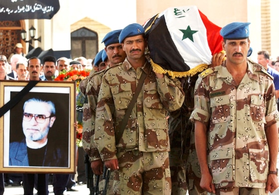 Iraqi security forces carry the coffin of the chairman of the Iraqi Governing Council, Izzadine Saleem, at a funeral service inside the Green Zone in Baghdad on Tuesday.