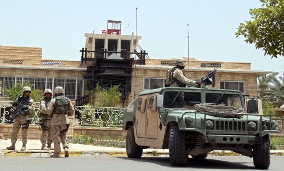 U.S Army soldiers stand guard Thursday outside the residence of Iraqi politician Ahmad Chalabi in Baghdad.