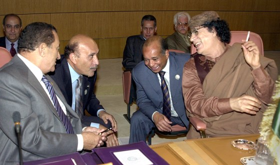 Libyan leader Moammar Gadhafi, right, talks with Egyptian President Hosni Mubarak, left, chief of Egyptian intelligence Omar Suleiman, second left, and his foreign minister Abdel-Rahman Shalqam at the opening of 16th session of the Arab Summit in Tunis, Tunisia, Saturday.