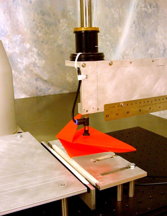 Balkcom’s robot uses a tiny suction cup attached to a mechanical arm to pick the paper up, rotate it and place it on the worktable.