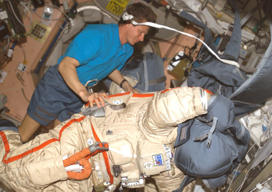 Russian cosmonaut Gennady Padalka, the international space station's commander, checks out his Orlan spacesuit. Such suits will have to be used during a spacewalk next month because of problems with two of the three U.S.-made spacesuits designed for extravehicular activity.
