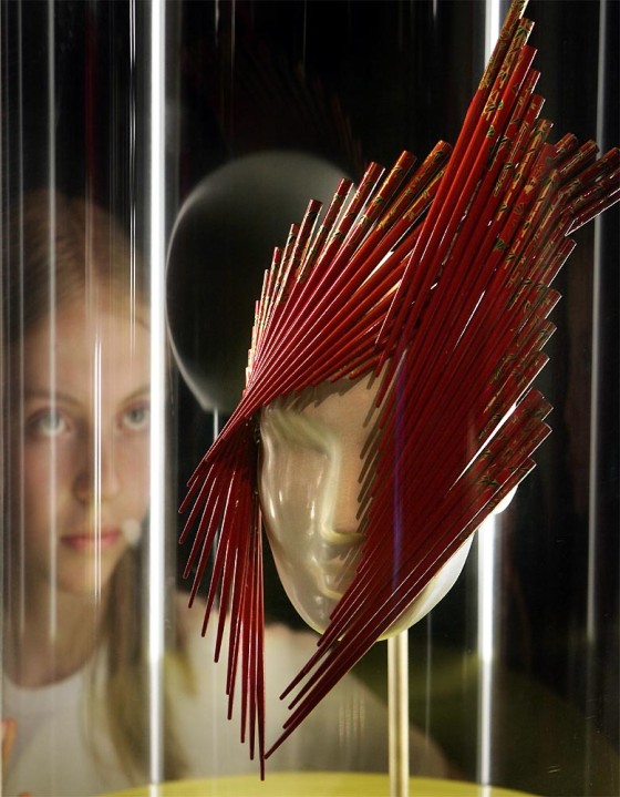 GIRL LOOKS AT A HAIR STYLE DESIGN AT NATURAL HISTORY MUSEUM IN LONDON