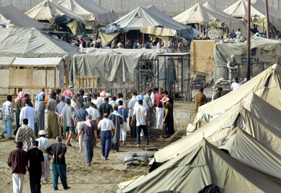 Detainees gather for the morning head count in an outdoor detention center in the Abu Ghraib prison on the outskirts of Baghdad. 