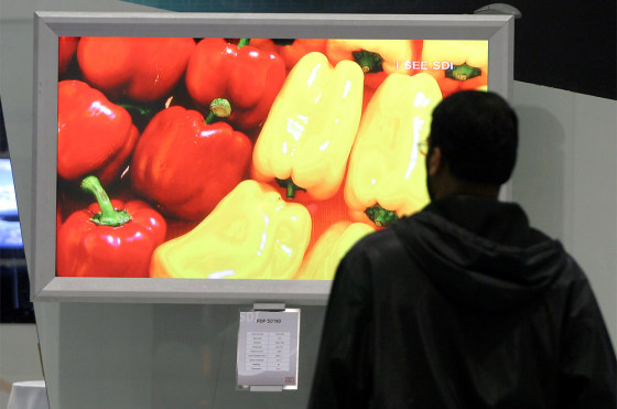 A vendor watches a Samsung ultra fine PDP 63-inch HD screen at the Society for Information Display expo in Seattle. 
