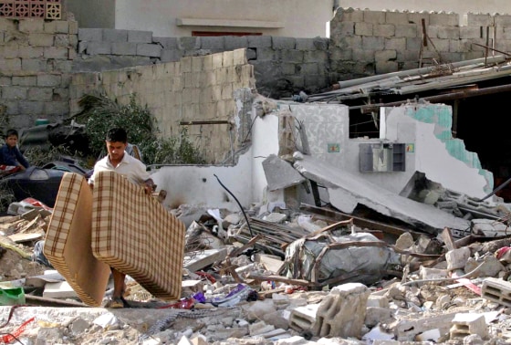 A Palestinian man carried his mattresses away from a house destroyed Thursday by Israeli forces in the Brazil neighborhood in the Rafah refugee camp.