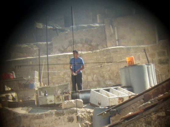 A photo taken through an Israeli soldier’s gunsight shows a Palestinian man in Hebron. The photo is part of an exhibit called "Breaking the Silence, Soldiers tell about Hebron" at the Academy for Geographic Photography.
