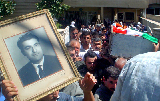 Mourners carry a portrait of, and the Kurdish flag-draped coffin containing, Ghazi Talabani, the top security official for the state-run Northern Oil company, during his funeral in Kirkuk on Wednesday.