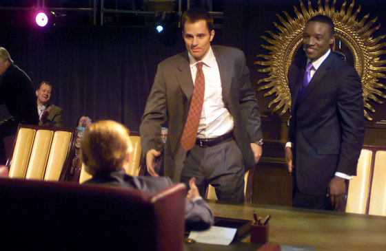 Bill Rancic, center, winner of "The Apprentice" walks up to shake hands with Donald Trump in the finale for the NBC show.