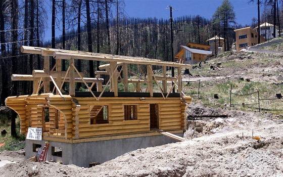 The Rainbow Gift Shop is being rebuilt along with homes on a hillside that the Aspen Fire destroyed in Summerhaven, Ariz., a year ago.
